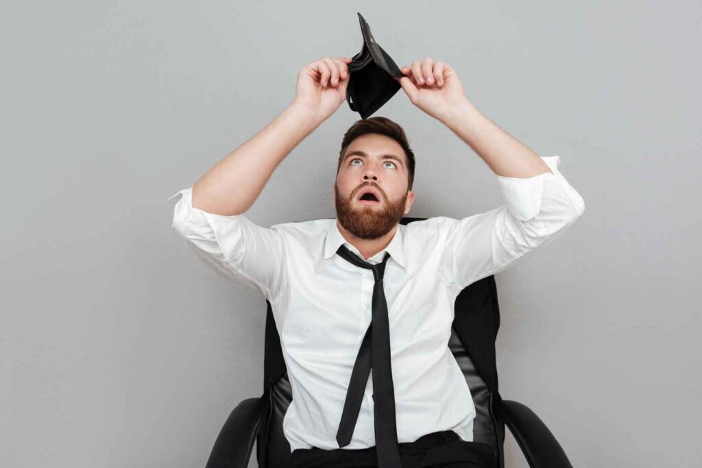 A self-employed person holding an open wallet with no money inside, looking concerned about financial challenges. The empty wallet symbolizes the struggle of irregular income and lack of traditional proof of income,